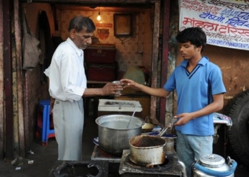 Ram Singh, một cậu bé đường phố 17 tuổi, kiếm được 1 USD/100 tách trà bán ra mỗi ngày, đều trích phân nửa số tiền để gửi vào ngân hàng Khazana ở New Delhi - Ảnh: AFP