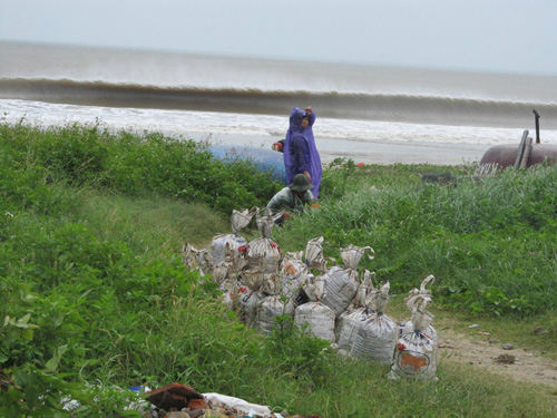 Tại bãi biển Đà Nẵng sáng nay, 14.10, nhiều người dân đổ ra xúc cát về chèn chống nhà cửa