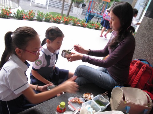 Chị Phương Chi mang cơm vào Trường tiểu học Nguyễn Văn Trỗi (Q.4, TP.HCM) cho con ăn sau giờ học để còn kịp giờ đi học thêm