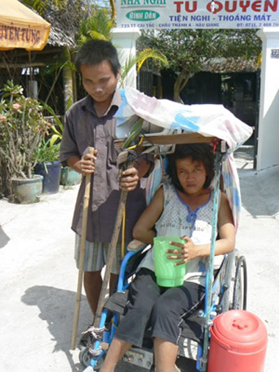 Vợ chồng anh Lư Trí Thức, chị Nguyễn Thị Thanh Nga trên đường phố ở phường Hiệp Thành