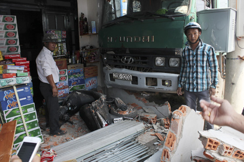 Chiếc xe tải đè sập một mảng tưởng rồi đè ngã xe tay ga đang dựng trong nhà