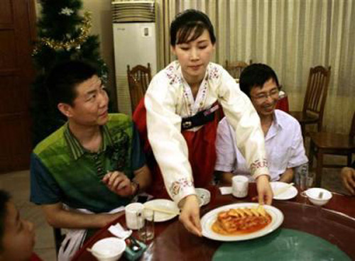 Nhân viên của một nhà hàng Triều Tiên ở Trung Quốc phục vụ khách địa phương hồi năm 2009