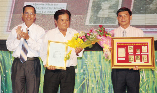 Ông Nguyễn Văn Lộc (bìa phải), Giám đốc Sở VH-TT-DL Bình Dương, nhận cuốn nhật ký và những kỷ vật đưa vào Bảo tàng Bình Dương