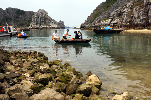 Nước cạn, khách đến thăm đảo phải chuyển tải trên thuyền nan