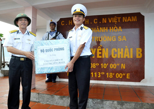 Thượng úy Trần Thanh Sơn (bên phải) nhận quà của đoàn công tác từ đất liền ra - Ảnh: Mai Thanh Hải
