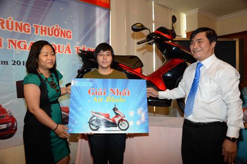 Phó tổng biên tập Báo Thanh Niên Nguyễn Ngọc Toàn (phải) và bà Bùi Hoàng Yến, Phó trưởng văn phòng đại diện Cục Xúc tiến thương mại, trao giải nhất xe Honda Air Blade cho bạn đọc Nguyễn Thị Mỹ Dung (Q.1, TP.HCM) 