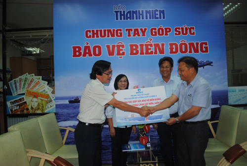 Ông Hoàng Lâm (bên phải) trao biểu trưng 120 triệu đồng cho đại diện Báo Thanh Niên