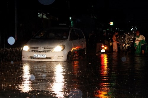 Tại đường Tân Hóa, Q.6 nước ngập cao gây khó khăn trong việc đi lại của người dân