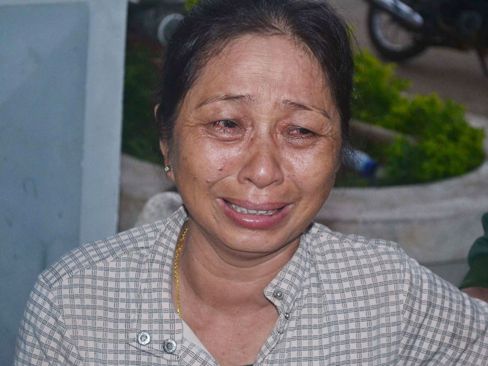 Bà Mai Thị Long (43 tuổi, vợ của ngư dân Bảy) khóc ngất khi đón thi thể chồng về đến đất liền