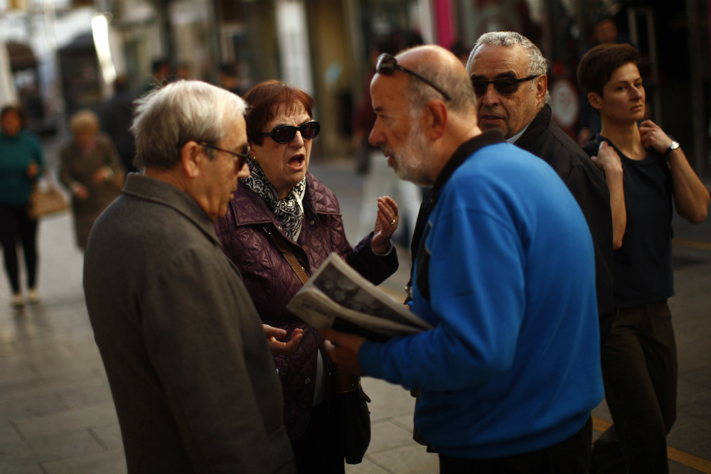 Người dân Tây Ban Nha bàn tán về chính trị trên đường phố, một ngày sau cuộc bầu cử có kết quả chia rẽ nhất trong lịch sử nước này - Ảnh: Retuers
