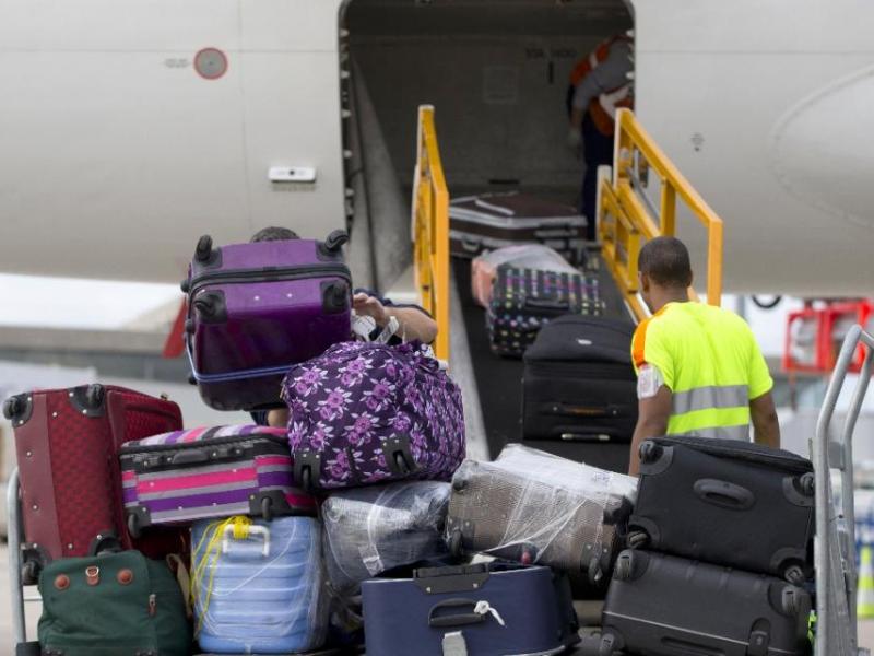 Đưa hành lý ký gửi lên máy bay tại Mỹ - Ảnh: AFP