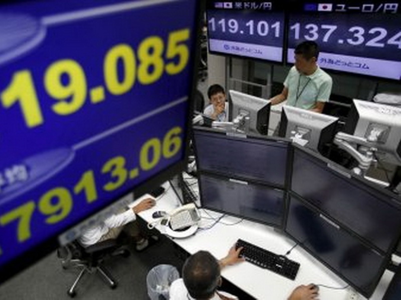 Cổ phiếu châu Á đồng loạt tăng giá sau khi Fed tăng lãi suất cơ bản - Ảnh: Reuters