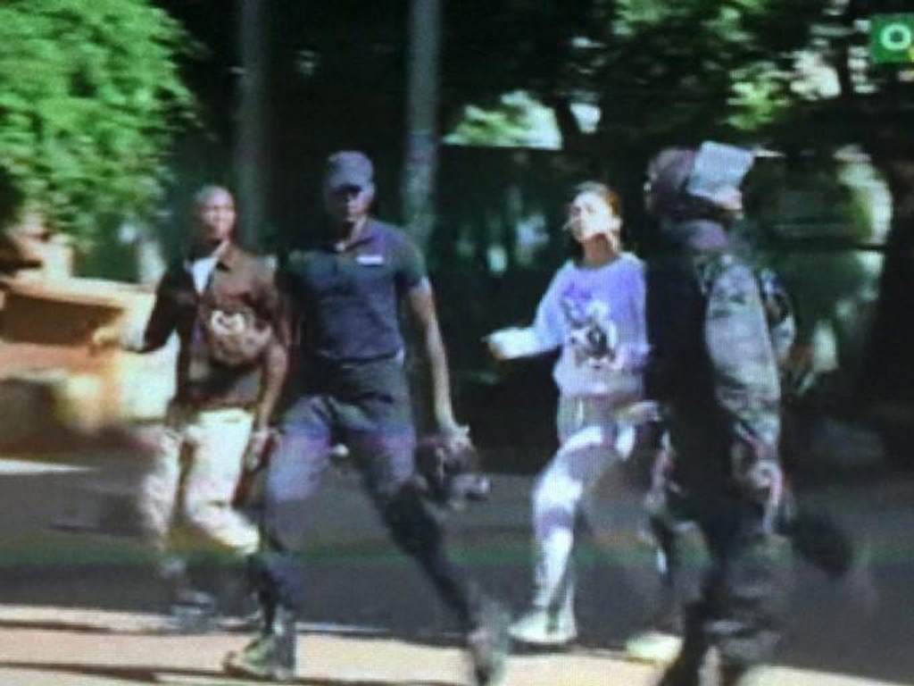 Đặc nhiệm Mali đưa con tin từ khách sạn ra ngoài - Ảnh: Reuters chụp truyền hình Mali
