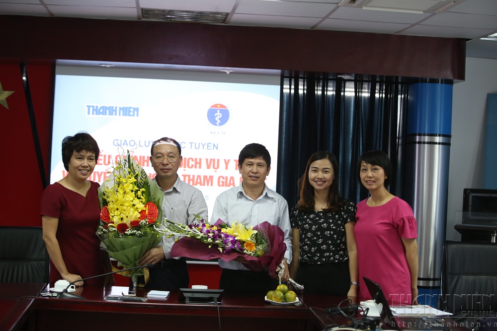 Bà Đặng Thị Phương Thảo, Phó tổng biên tập báo Thanh Niên (bìa trái) tặng hoa khách mời - Ảnh: Ngọc Thắng