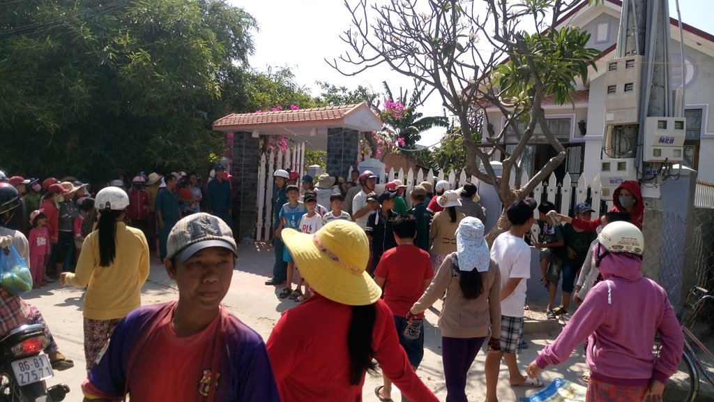 Rất nhiều người dân đứng trước cổng nhà nạn nhân - Ảnh: Quế Hà