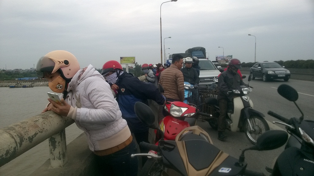 Người dân hiếu kỳ đứng trên cầu Phú Lương theo dõi lực lượng chức năng tìm kiếm thi thể chị K.A - Ảnh: Thành Trí