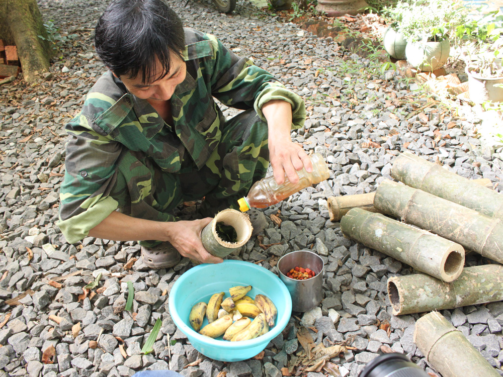 Anh Trần Văn Quản, đội trưởng đội cứu hộ đang trộn thức ăn cho gấu - Ảnh: Tiểu Thiên