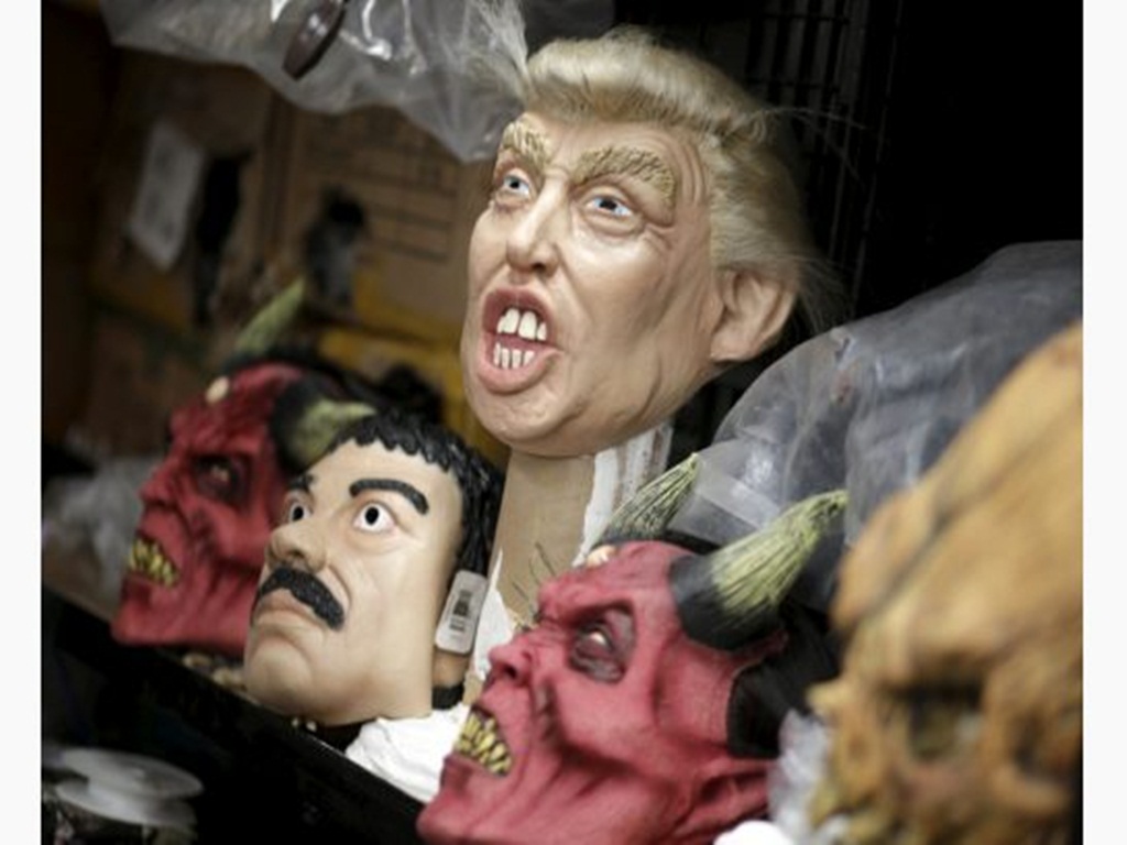 Mặt nạ hình ông Donald Trump với khuôn miệng há hốc cùng mặt nạ trùm vượt ngục El Chapo có bộ râu đặc trưng đang bán chạy tại Mexico - Ảnh: Reuters