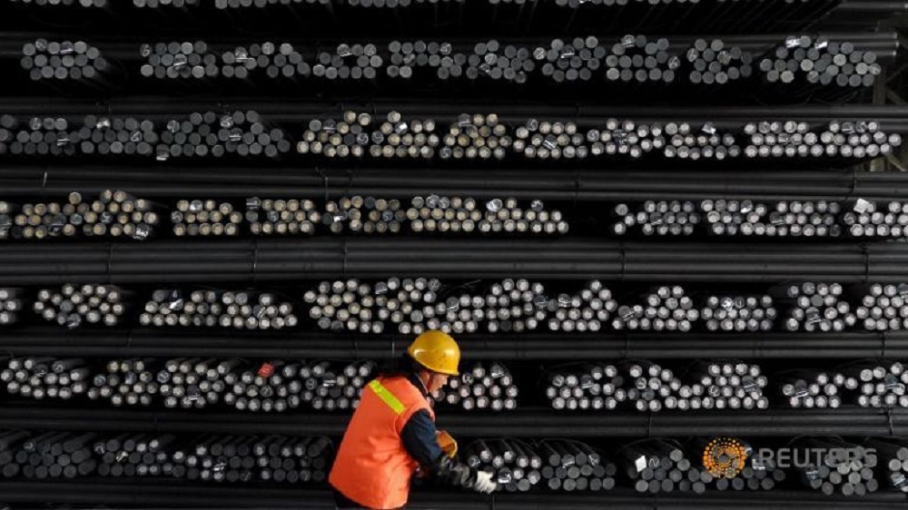 Một người lao động đánh dấu các thanh thép tại nhà máy thép ở tỉnh Giang Tô (Trung Quốc) - Ảnh: Reuters