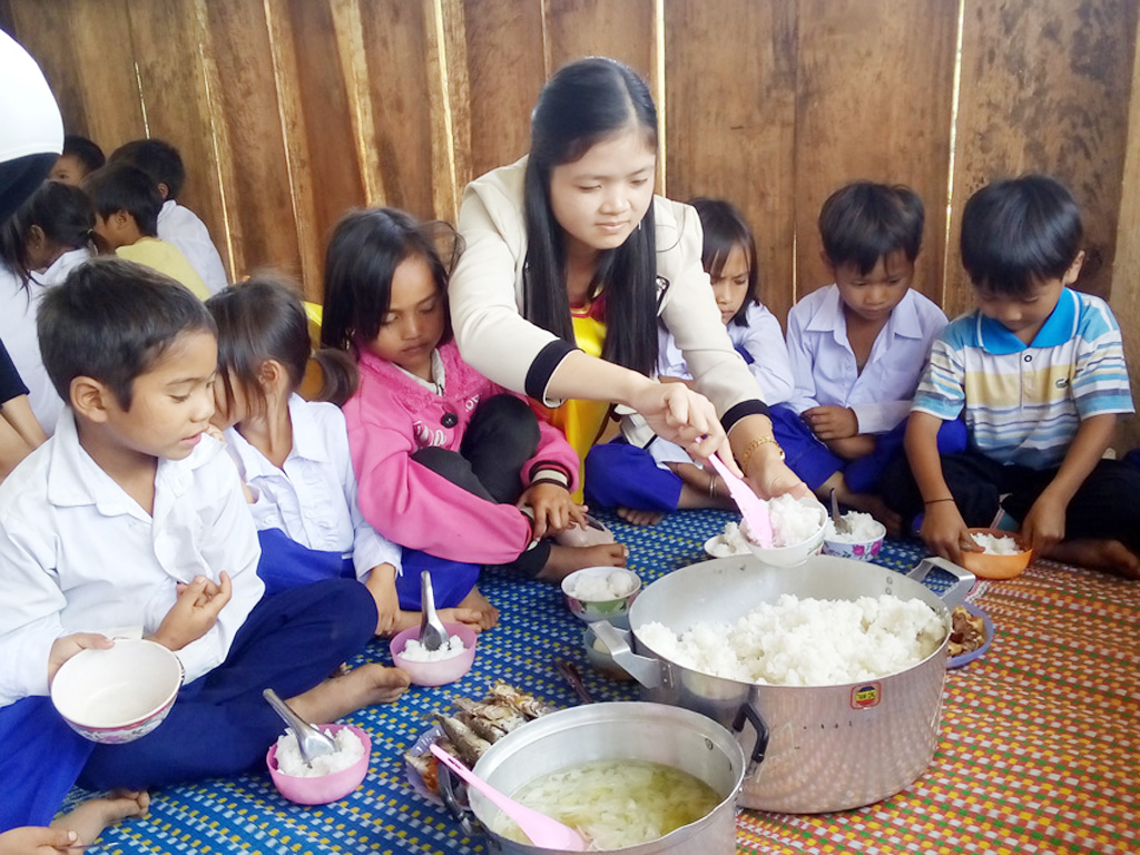Giáo viên Trường dân tộc bán trú Măng Ri, huyện Tu Mơ Rông (Kon Tum) chăm sóc bữa ăn trưa cho học sinh - Ảnh: Phạm Anh
