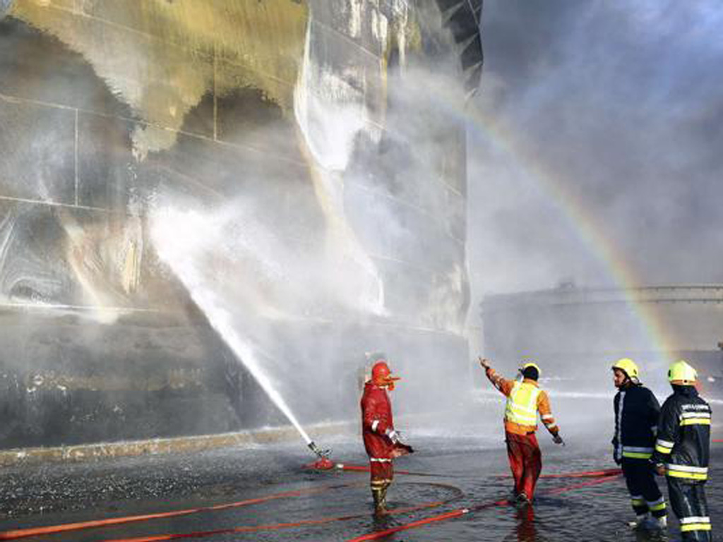 Lính cứu hoả đang chữa cháy tại một kho xăng dầu ở Es Sidr, Libya - Ảnh: Reuters