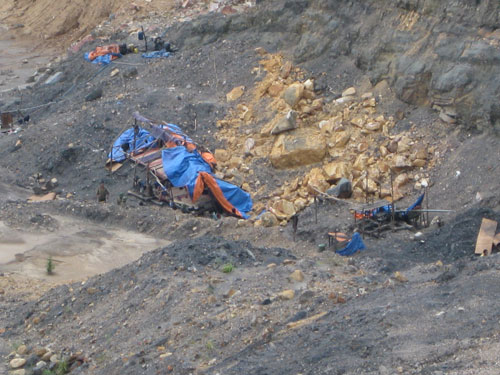 Những lán trại các chủ lò “thổ phỉ” dựng cho công nhân ở ngay tại cửa lò khai thác - Ảnh: Linh Linh
