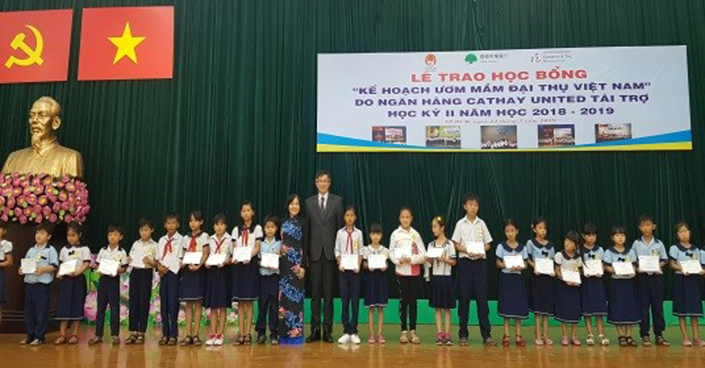 Ông Juan Feng Li, Tổng giám đốc Ngân hàng Cathay United (áo đen) cùng Đại diện chính quyền địa phương trao học bổng cho các em học sinh tiểu học tại TP.HCM 