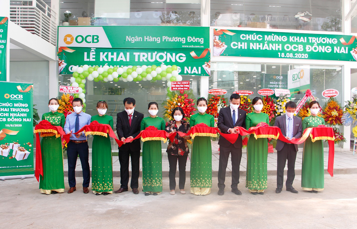 Đại diện lãnh đạo OCB và khách hàng, thực hiện nghi thức cắt băng khai trương trụ sở mới chi nhánh Đồng Nai