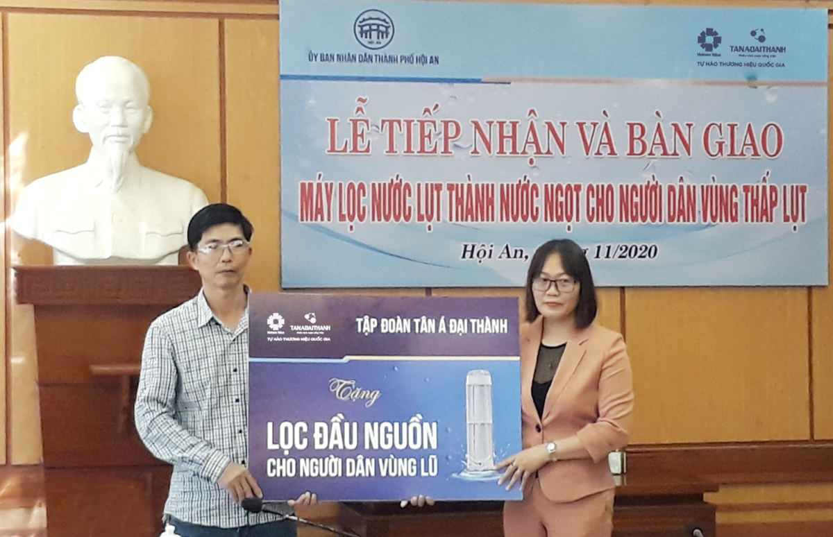 Đại diện Tập đoàn Tân Á Đại trao tặng máy lọc nước đầu nguồn cho người dân vùng lũ