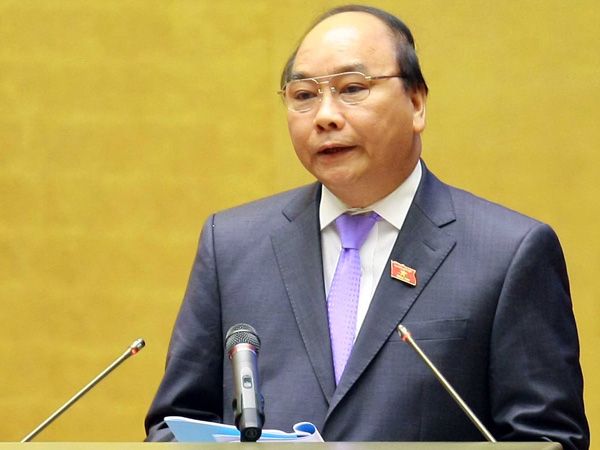 Phó thủ tướng Nguyễn Xuân Phúc thay mặt Chính phủ trình bày báo cáo trước Quốc hội hôm qua 