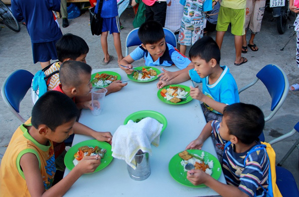 Các học sinh đến sớm ăn cơm trước khi bắt đầu buổi học 
