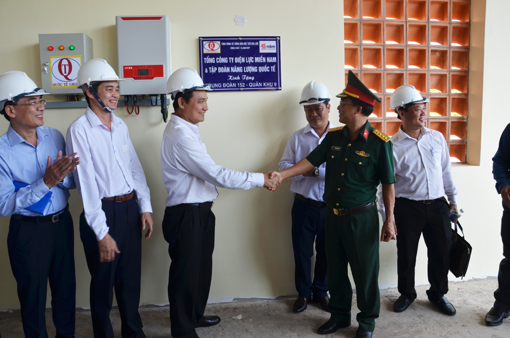 Ông Nguyễn Văn Hợp, Chủ tịch Hội đồng thành viên EVNSPC (thứ 3 từ trái qua), đại diện EVNSPC trao tặng Trung đoàn 152 hệ thống năng lượng mặt trời áp mái