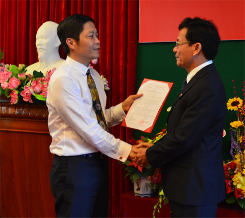 Thứ trưởng Bộ Công thương Trần Tuấn Anh (trái) trao quyết định bổ nhiệm Hiệu trưởng Trường ĐH Công nghiệp TP.HCM cho tiến sĩ Nguyễn Thiên Tuế