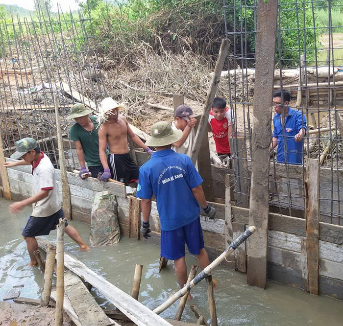 Dầm nắng, hốt bùn non để làm đập thủy lợi ở xã Hòa Tân Đông - Ảnh: Đức Huy