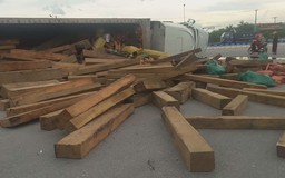 Xe container chở hơn 20 tấn gỗ lật giữa đường
