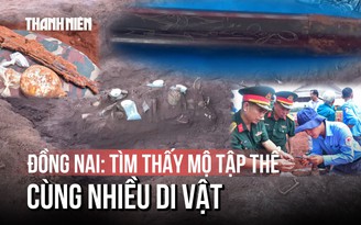 Cận cảnh chiếc bút khắc hình chim bồ câu và 2 chữ 'Tiến Quy' dưới mộ tập thể