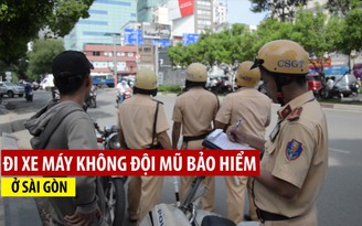 Phạt hàng loạt người xe máy không đội mũ bảo hiểm ở trung tâm Sài Gòn